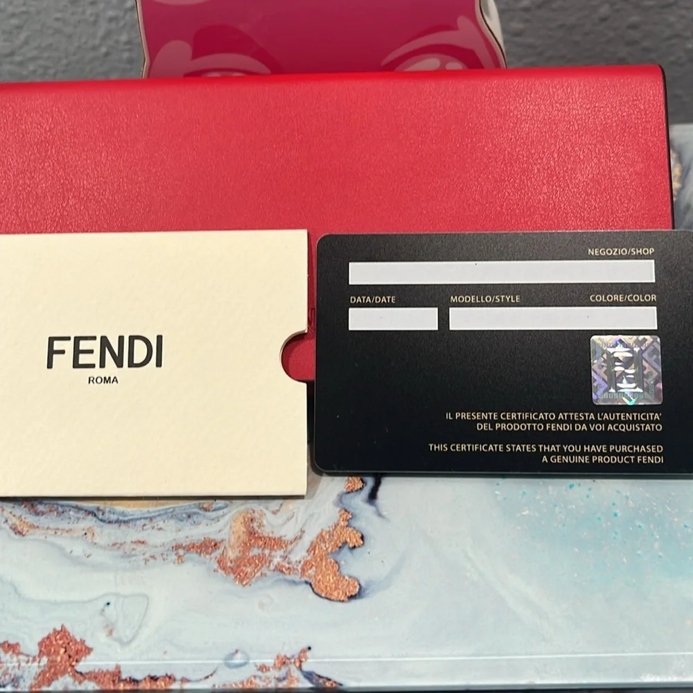 Fendi sunglasses with case, cleaning cloth, and authentication card